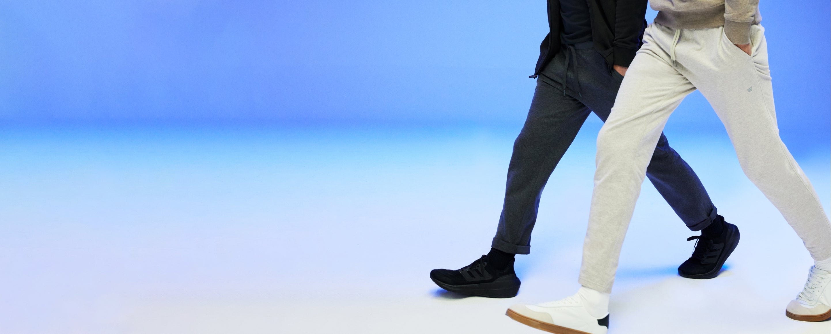 waist down image of two mean walking wearing ACE sweatpants