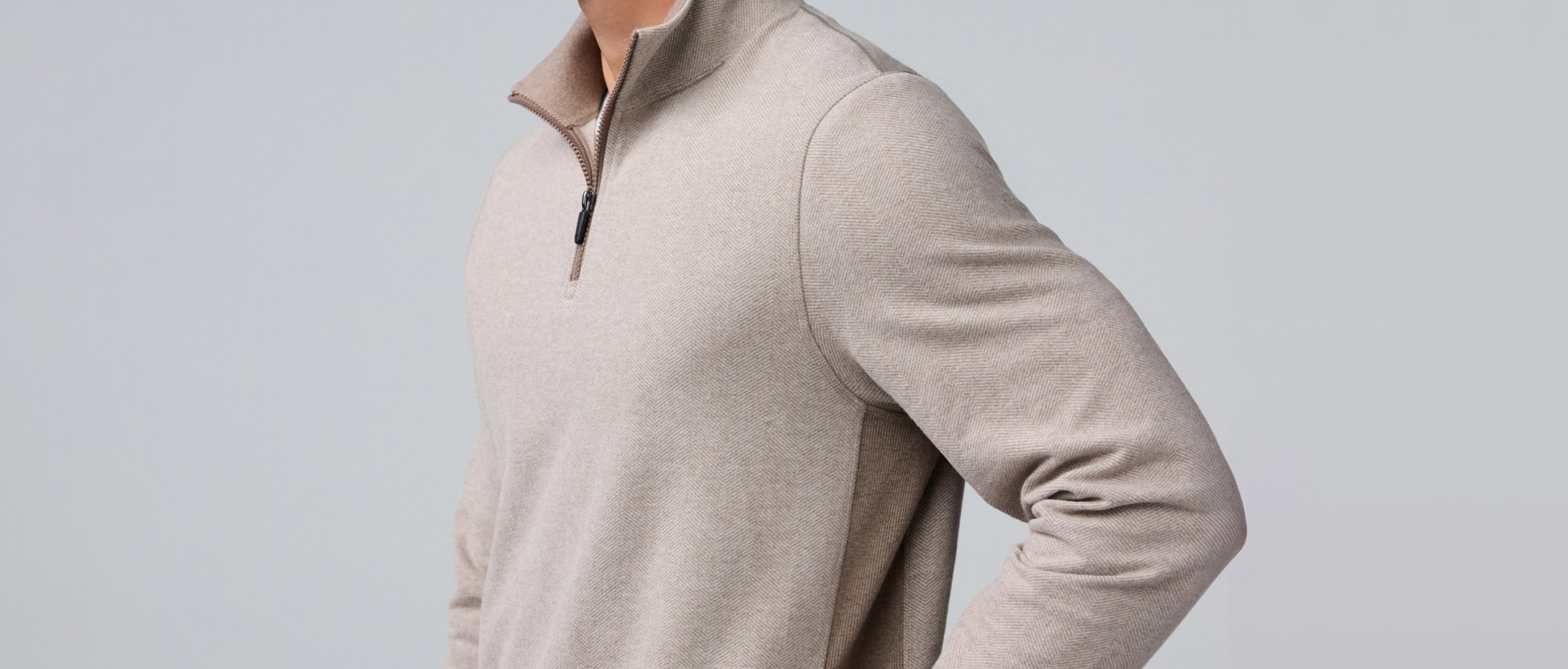torso of a man wearing a cream ACE half-zip