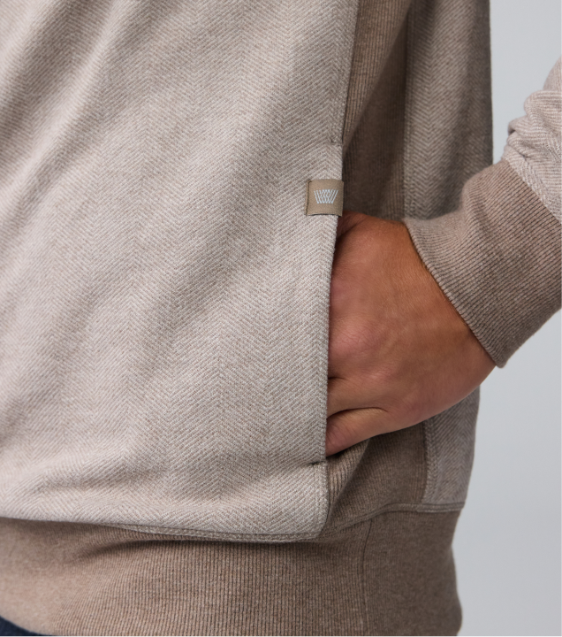 close up of a man's hand in the side pocket of the ACE Half Zip