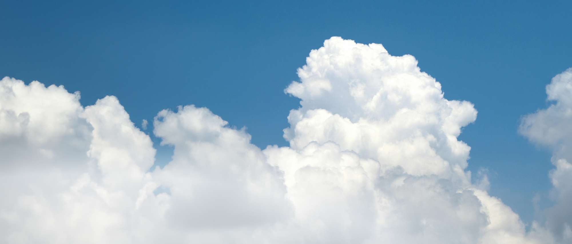 Image of a big white cloud against a bright blue sky