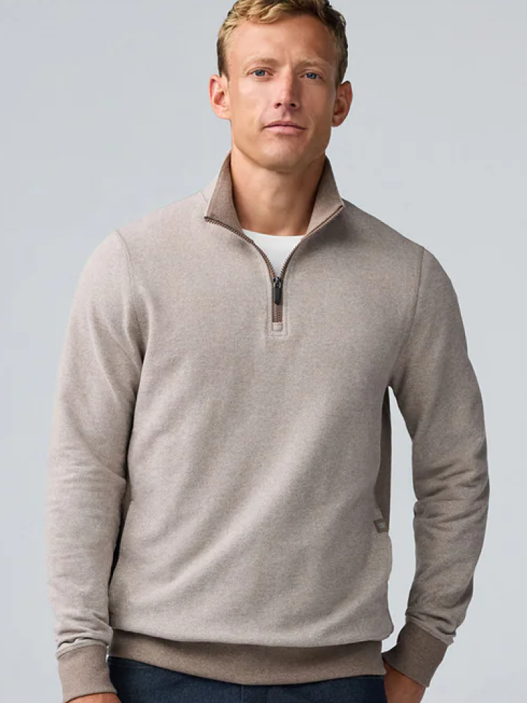 Man wears a cream ACE half-zip