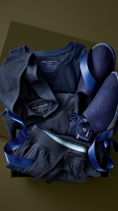 Dark blue clothing items including a shirt, shorts, and pants on a brown background