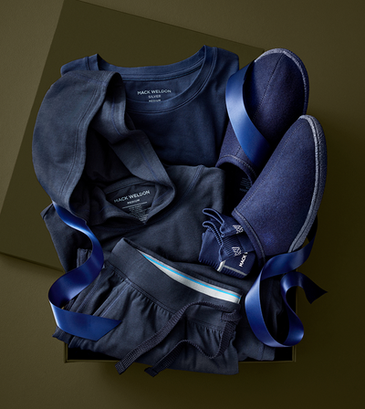 Navy blue children's outfit with shoes on a dark background
