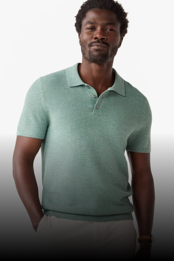 Man wearing a green polo shirt against a gradient background