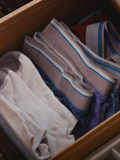 Close-up of a wooden drawer filled with Mack weldon Boxer briefs and Socks