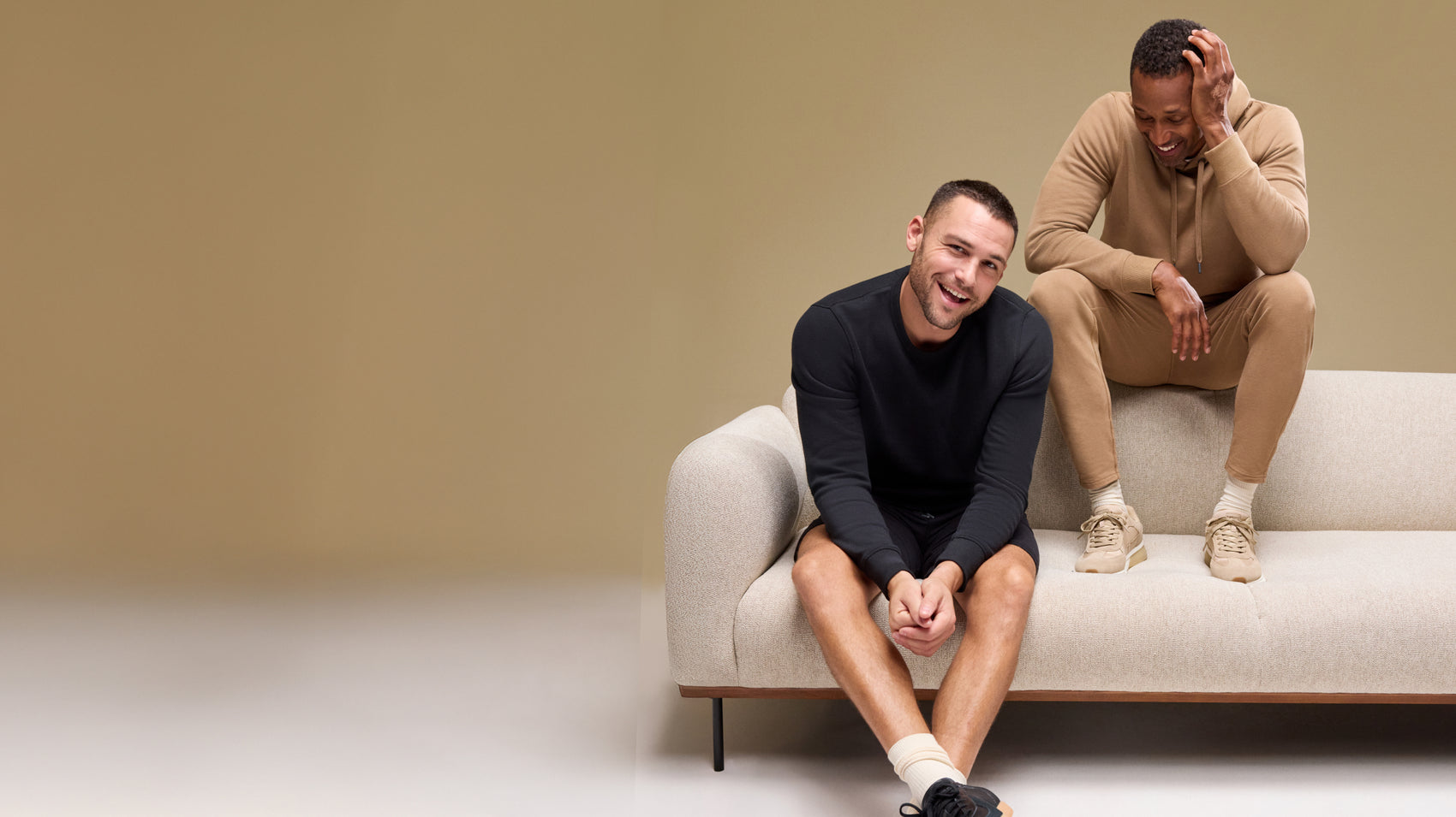 Two men wearing Ace Collection products; one wearing ACE Hoodie Sweat Set in Shroom and one wearing ACE Crew Neck Sweatshirt and ACE Sweatshort 9”
in True Black 