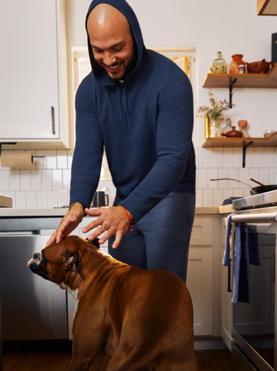 Man petting a dog wearing Tech Linen Hoodie in Navy Heather