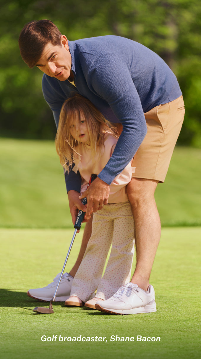 Man with his daughter playing golf