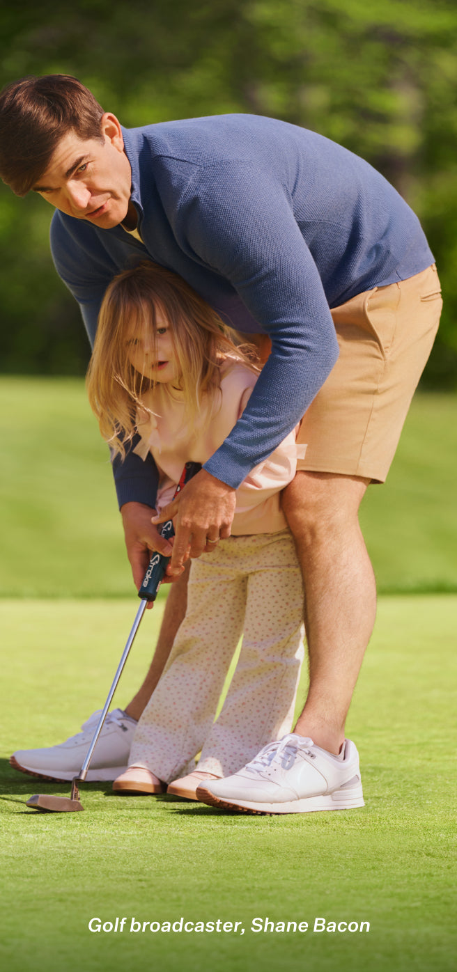 Man with his daughter playing golf