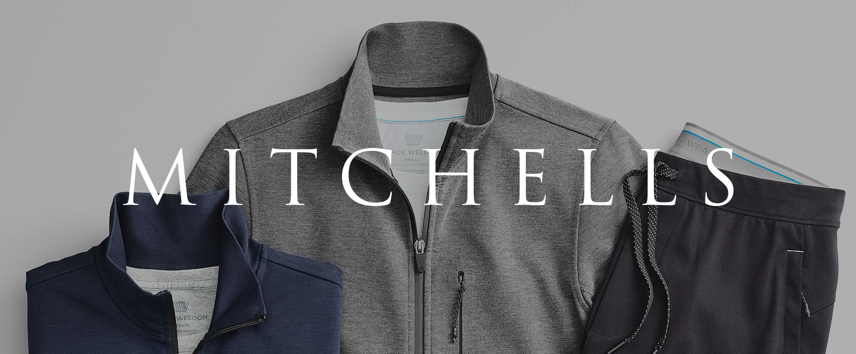 Jacket and sweatpants laid out with a "MITCHELLS" logo across the image