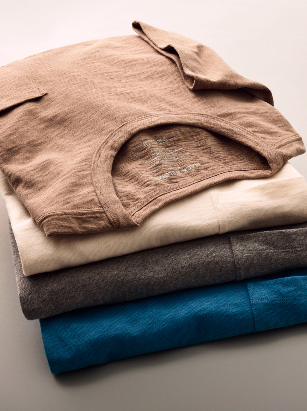 Stack of four shirts from the Slub Collection