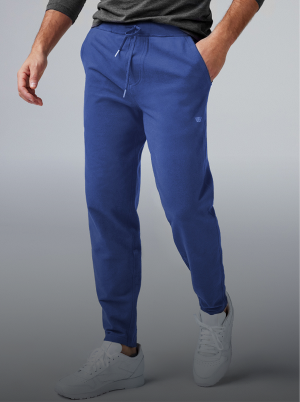 Person wearing blue jogger pants and white sneakers.