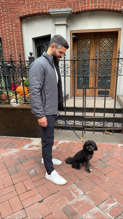 Man walking dog in WARMKNIT 2-Way Puffer and Radius Flex Jogger