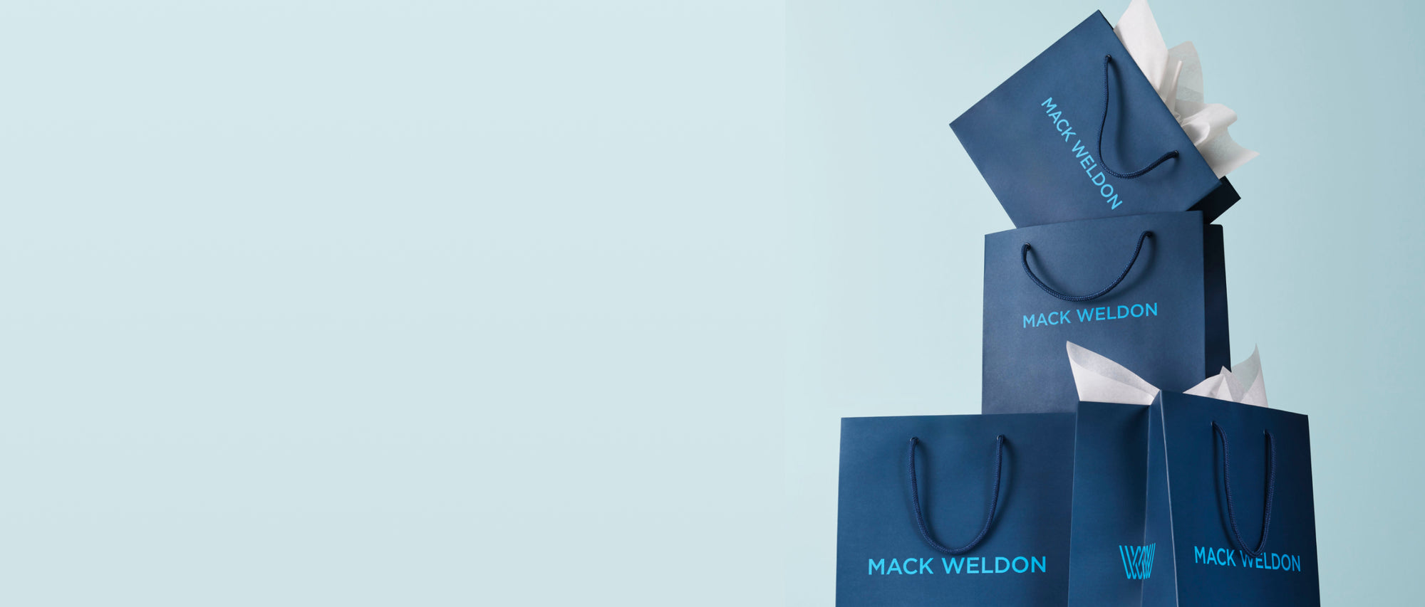 Stacks of Mack Weldon Shopping Bags
