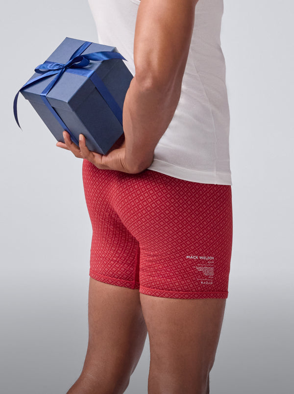 Man holding a gift and wearing Mack Weldon 18 hour jersey boxer brief