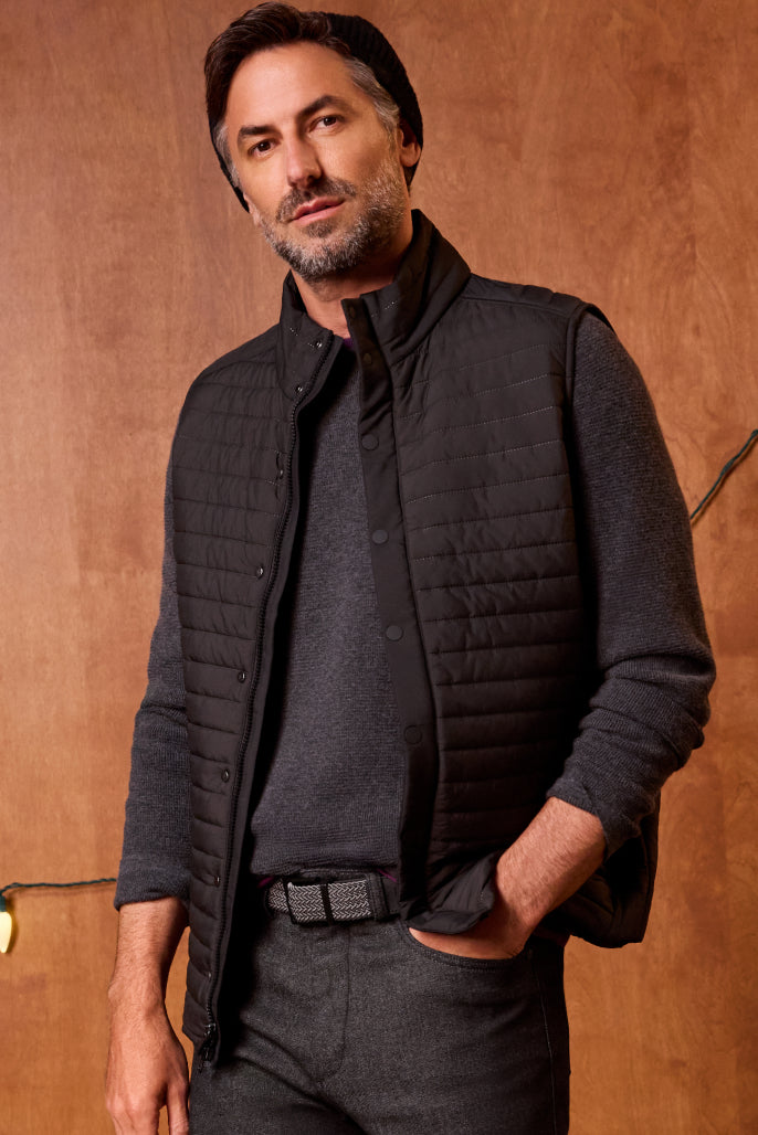 Man wearing WARMKNIT AIR Puffer Vest in True Black color