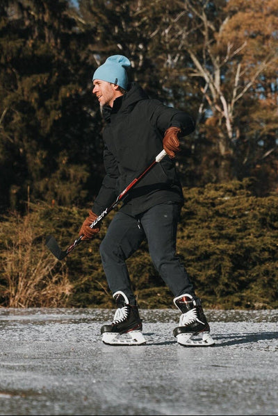 Man playing hockey wearing Mack Weldon apparel