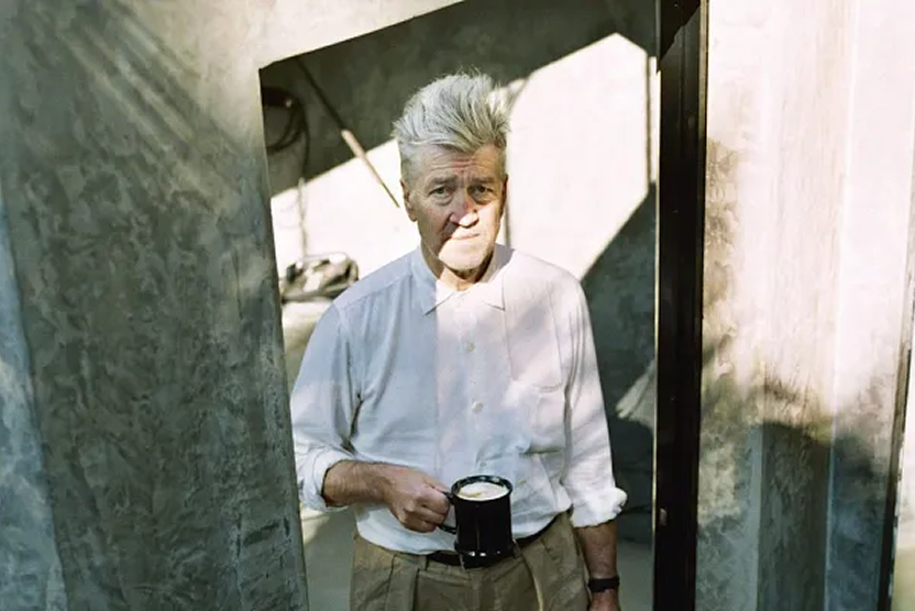 older man holding a coffee