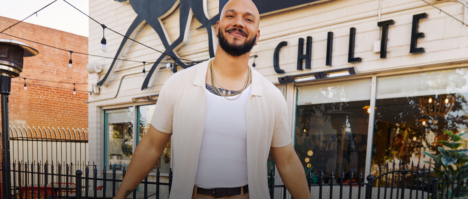 Chef L.T. Smith standing in front of Chilte wearing a Tech Linen Button Up Sweater Polo