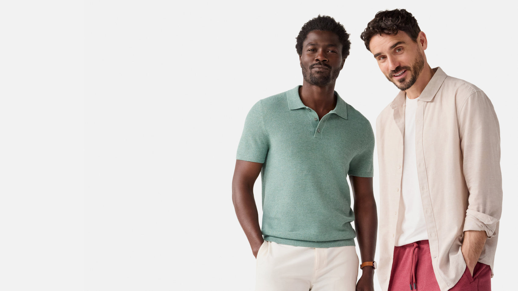 Two men standing side by side against a white background