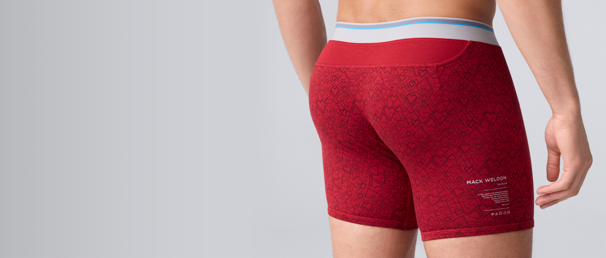 Airknitx Red boxer briefs with a geometric heart pattern and printed text on the side.