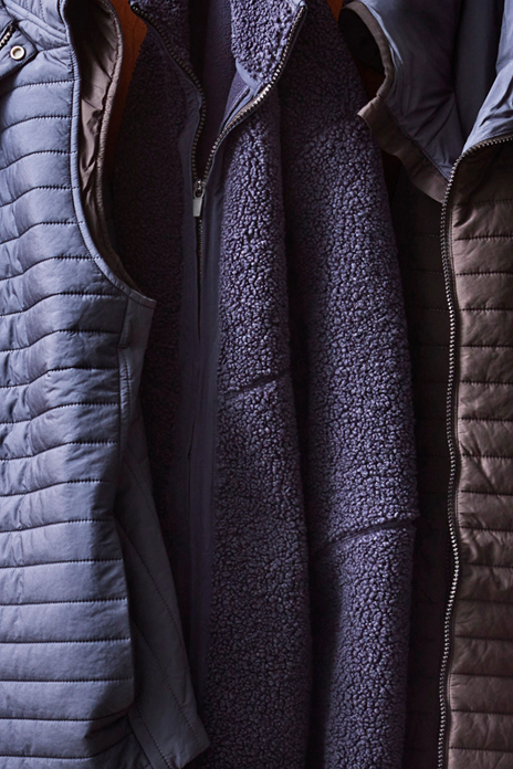Close-up of a layered jacket with quilted and fleece materials.