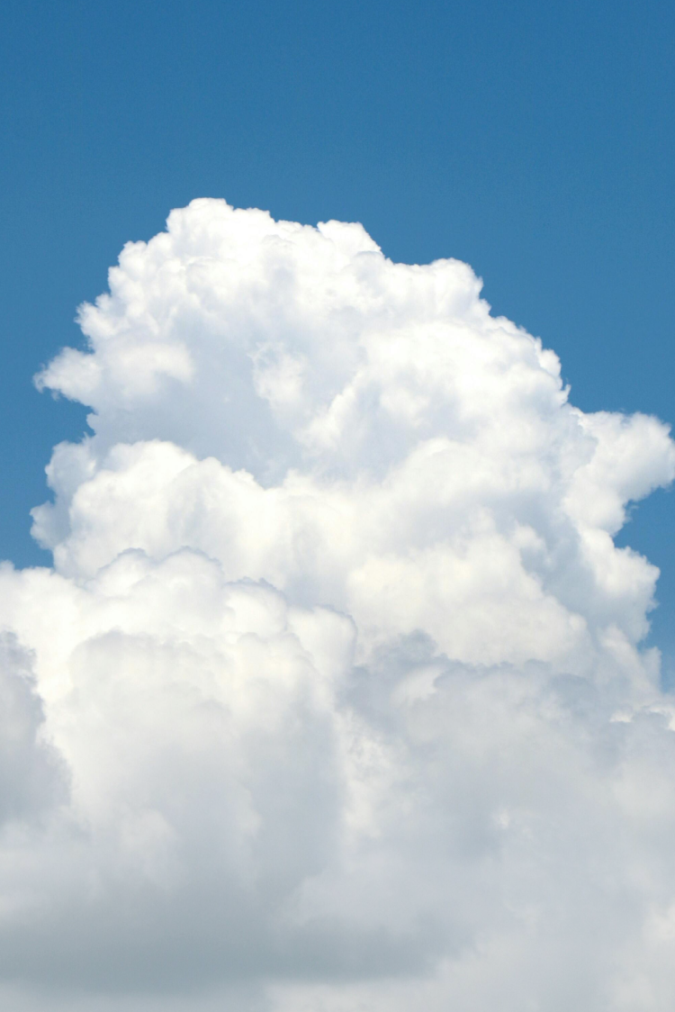 Image of a big white cloud against a bright blue sky
