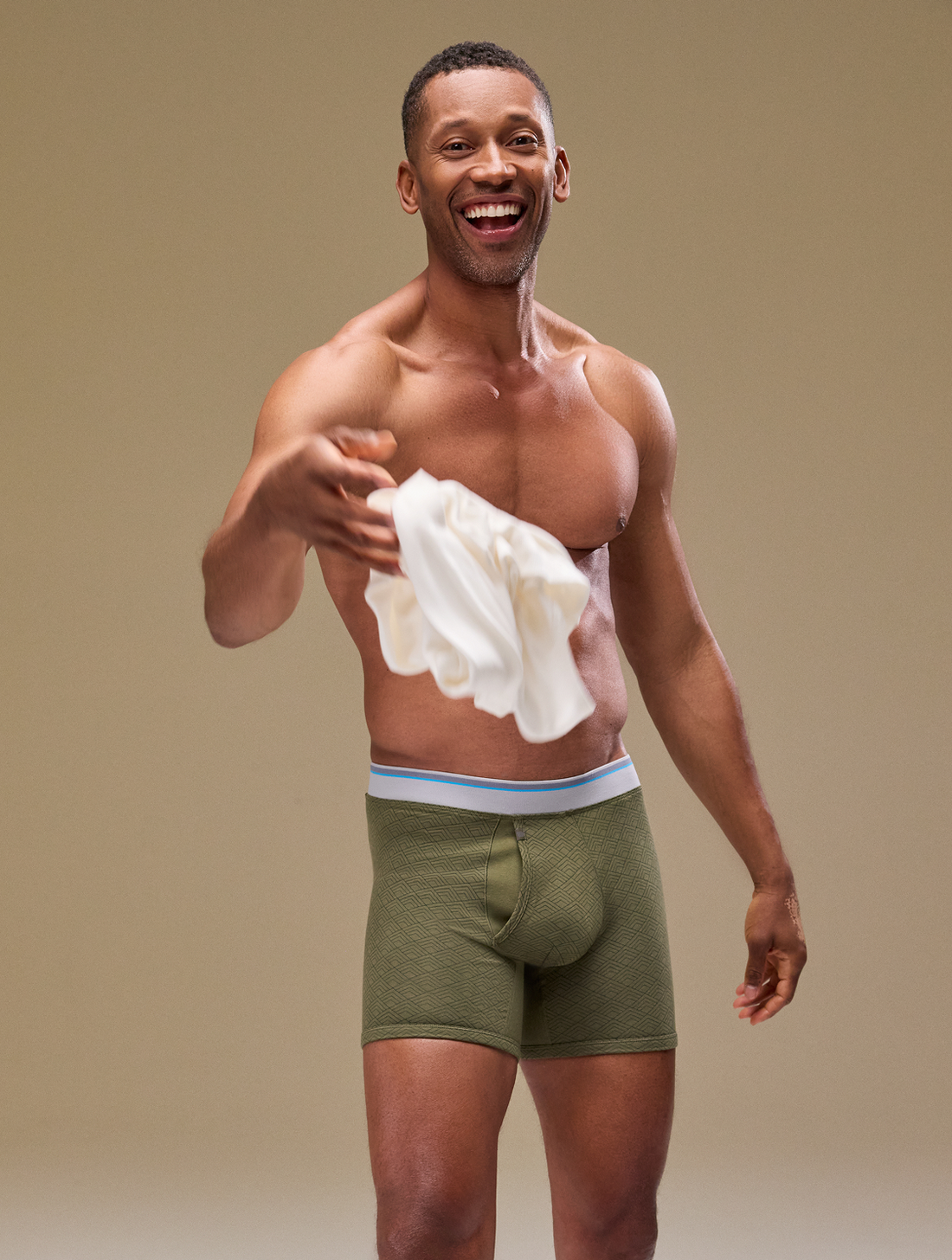 Man in underwear flinging a shirt towards the camera