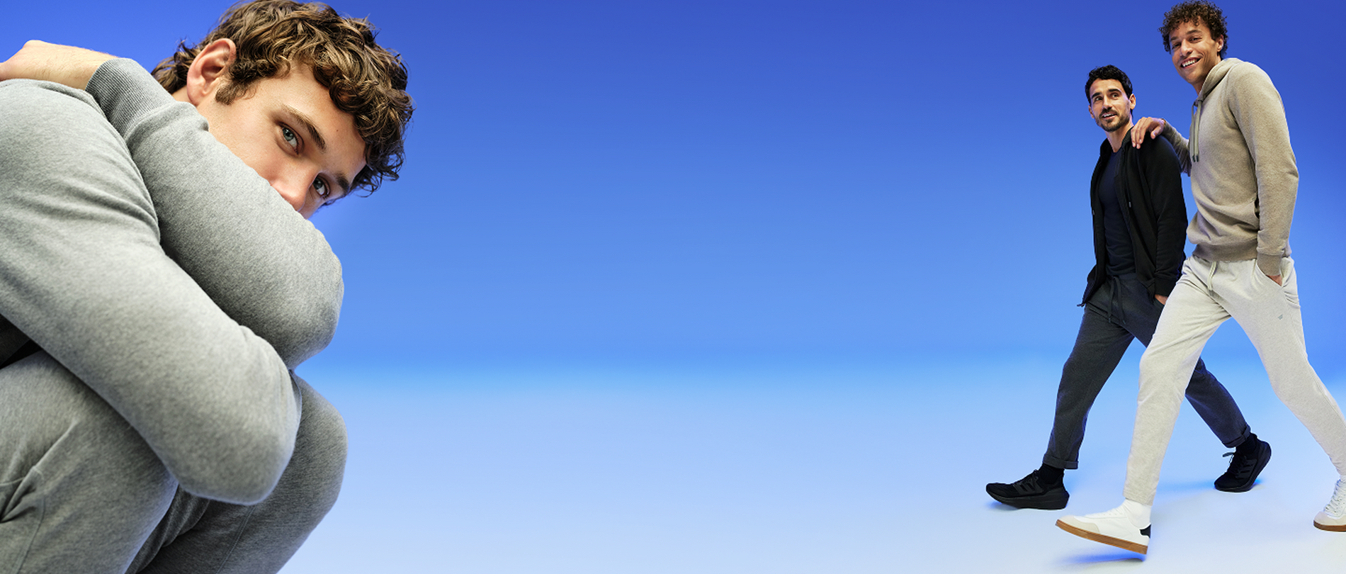 blue backdrop with three men