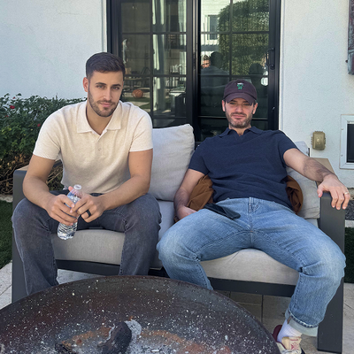 Two men sitting on a sofa wearing Tech Linen Sweater Polo