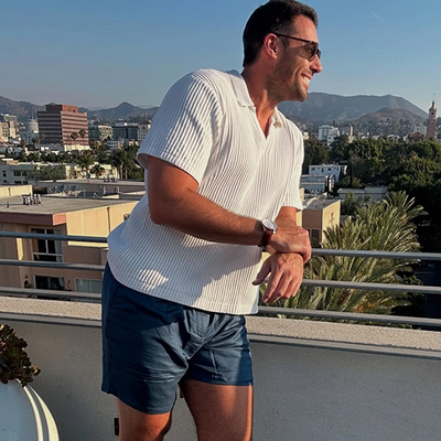 Man with a sunglass wearing a white top and featuring Mack Weldon Tech Linen Pleated Short