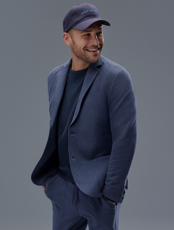 man wears a cap and relaxed blazer